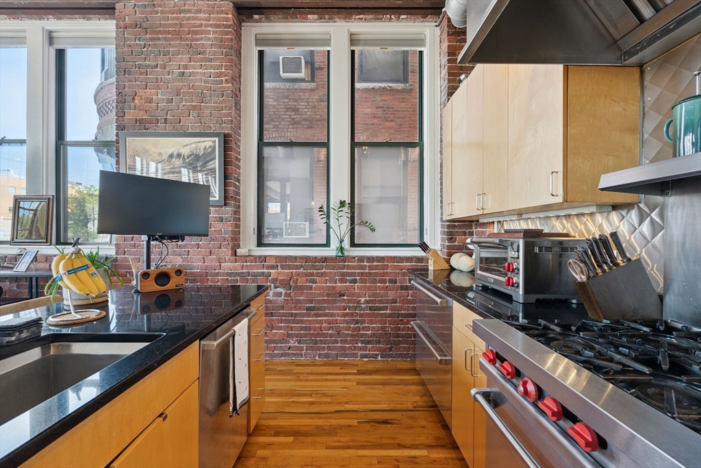 13-17 Willow Street, Unit 206 Lynn, MA 01901 - Photo 4 of 39 a bathroom with a sink and a mirror
