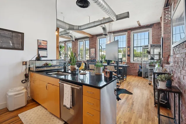 a kitchen with sink a stove and chairs