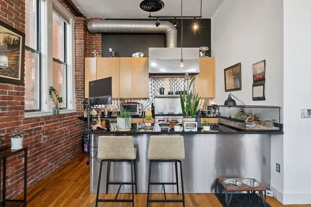 a kitchen with a table chairs stove and cabinets