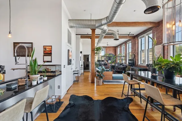 a living room with fireplace furniture and a large window