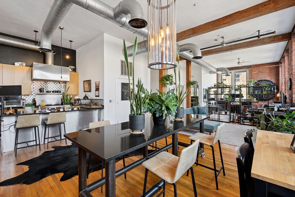 13-17 Willow Street, Unit 206 Lynn, MA 01901 - Photo 8 of 39 a view of a dining room with furniture and a potted plant