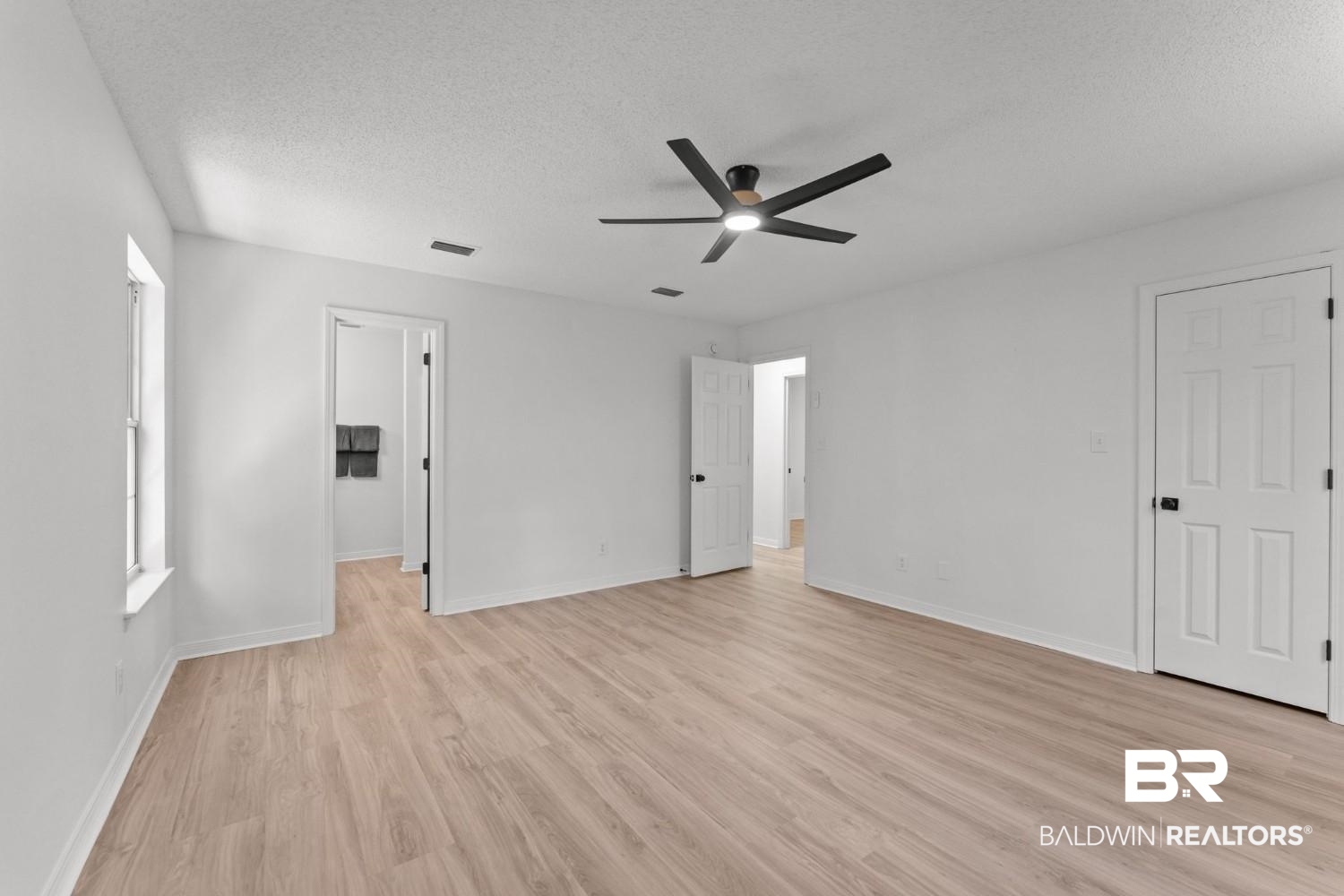 10251 Windmill Road Fairhope, AL 36532 - Photo 29 of 44 Unfurnished bedroom featuring light wood-style flooring, a textured ceiling, and a ceiling fan