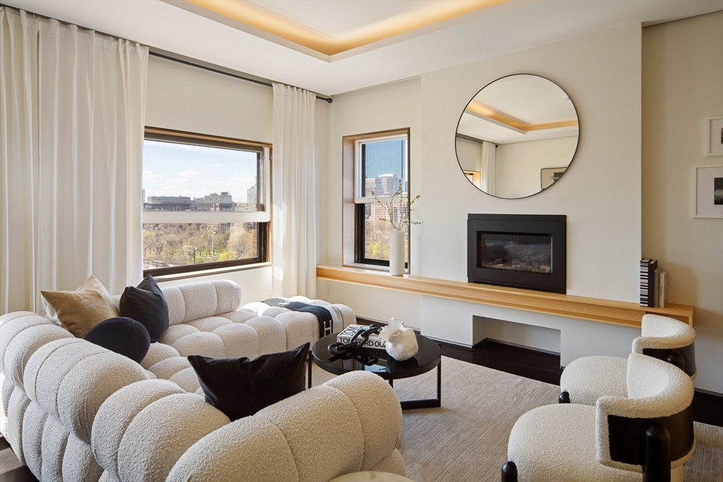 48 Beacon Street, Unit 12F Boston, MA 02108 - Photo 2 of 21 a living room with furniture a window and a fireplace