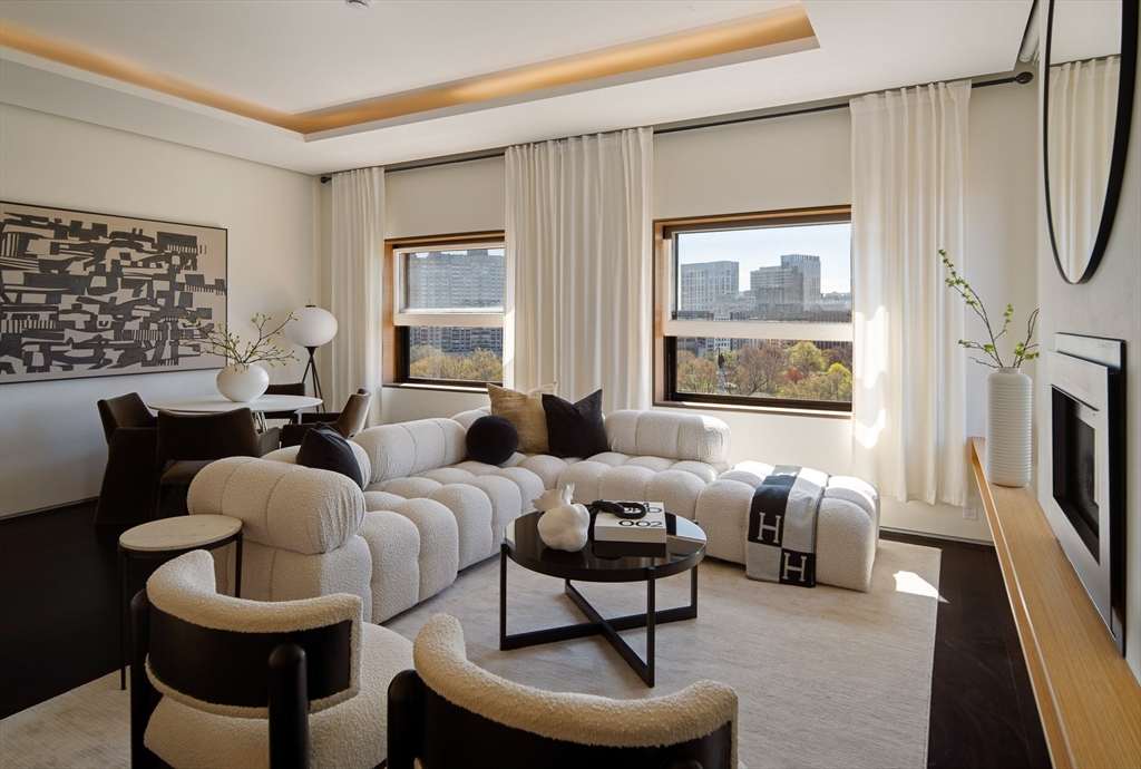 48 Beacon Street, Unit 12F Boston, MA 02108 - Photo 3 of 21 a living room with furniture a fireplace and a large window