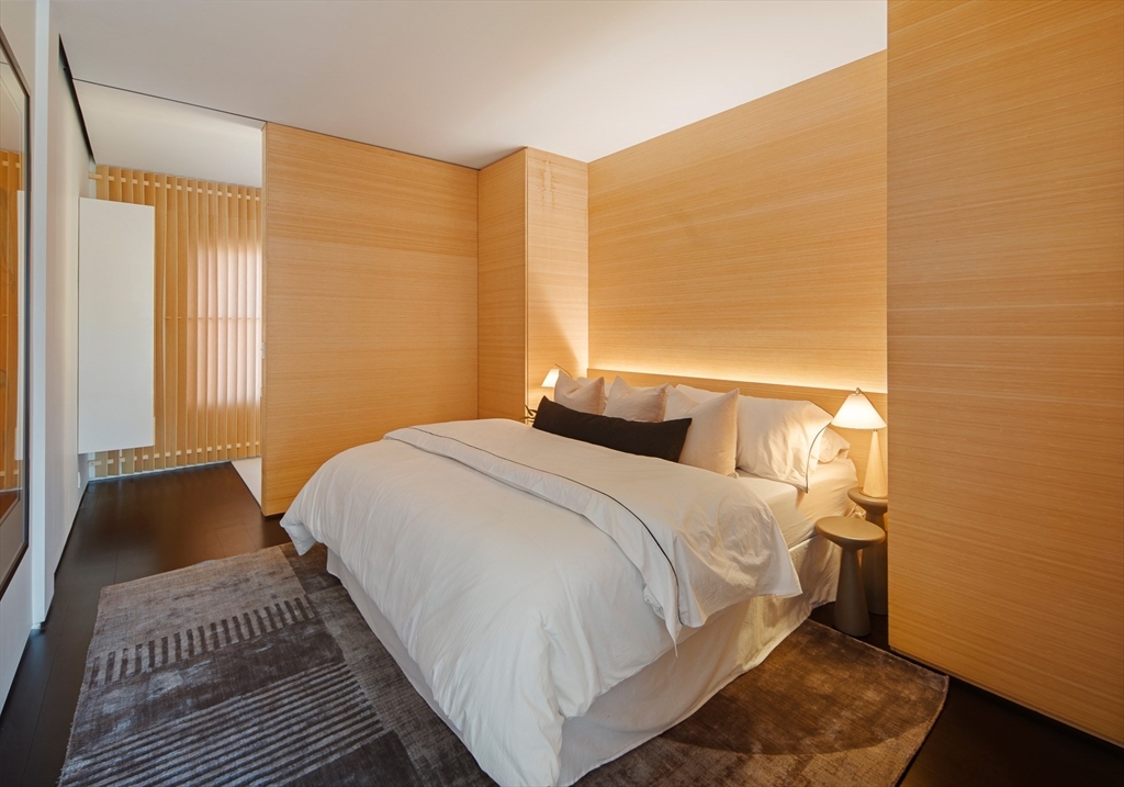 48 Beacon Street, Unit 12F Boston, MA 02108 - Photo 9 of 21 a bedroom with a bed and wooden floor