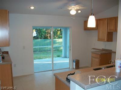 8136 Anhinga Road Fort Myers, FL 33967 - Photo 3 of 6 a living room with furniture and a flat screen tv