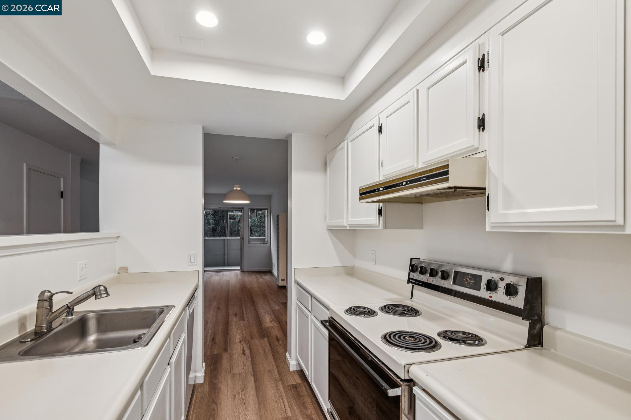 73 Brookwood Road, Unit 11 Orinda, CA 94563 - Photo 4 of 11 a kitchen with granite countertop a sink a stove and refrigerator