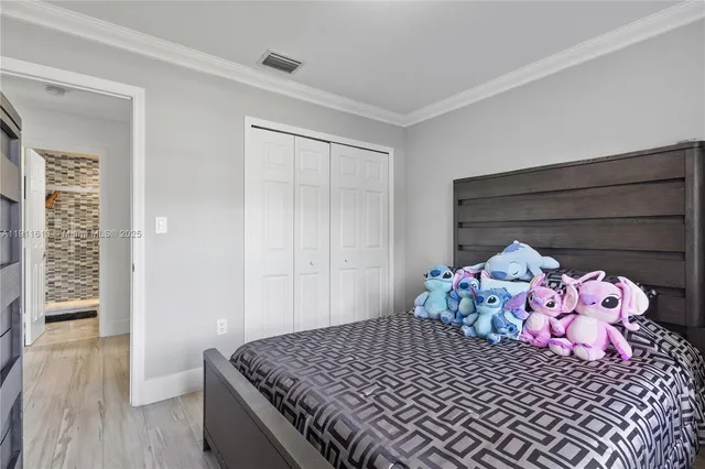 a large bed sitting in a bedroom next to a window