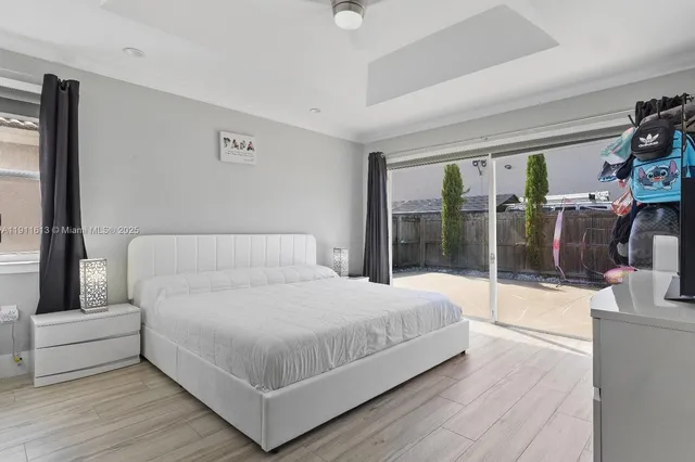 a bathroom with a granite countertop toilet a sink a mirror and a window