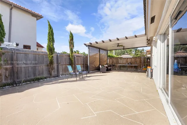 a view of a storage & utility room with refrigerator and wooden floor