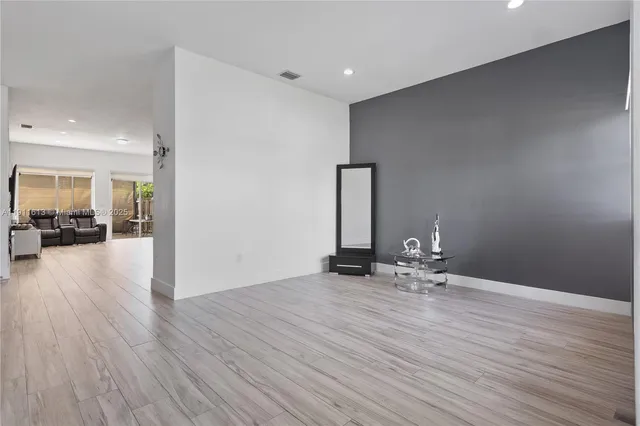 a view of an empty room and wooden floor