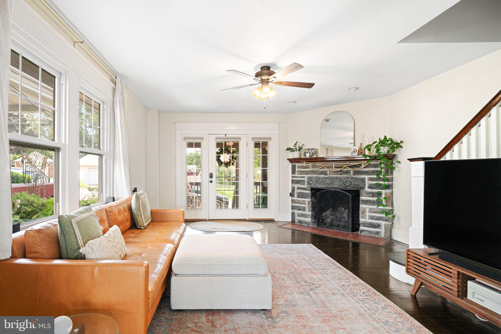 a living room with furniture flat screen tv and a fireplace