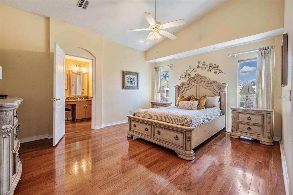 1042 Dustan Place Trinity, FL 34655 - Photo 13 of 48 a bedroom with a bed and a chandelier