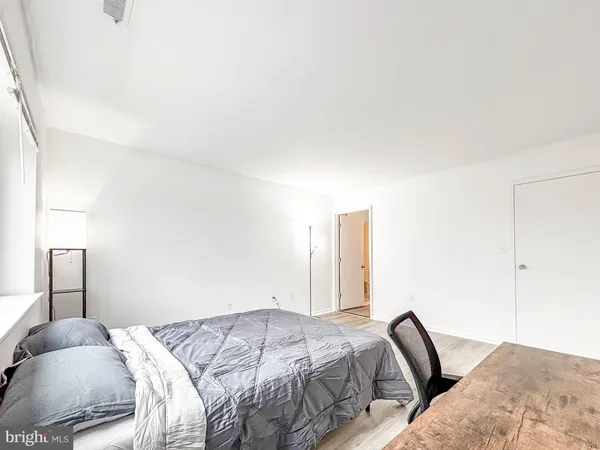 a bed sitting in a bedroom next to a window