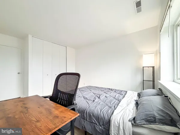 an empty room with wooden floor and door