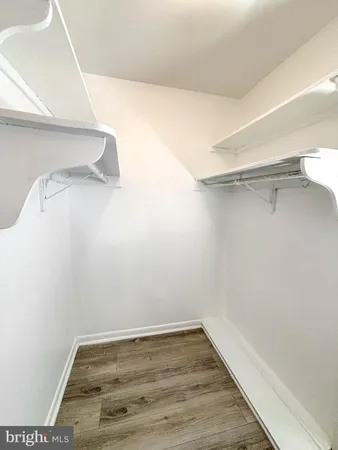 a kitchen with a stove a refrigerator and a white cabinets