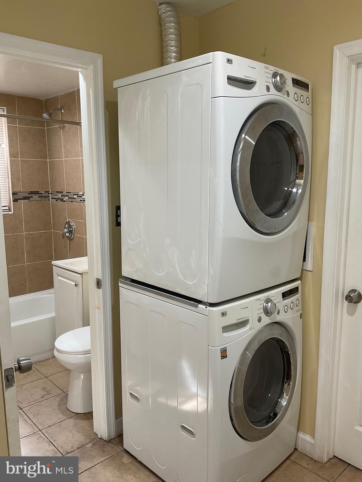 6 Galveston Street Southwest, Unit 103 Washington, DC 20032 - Photo 14 of 17 a view of a bathroom with a toilet and a washing machine