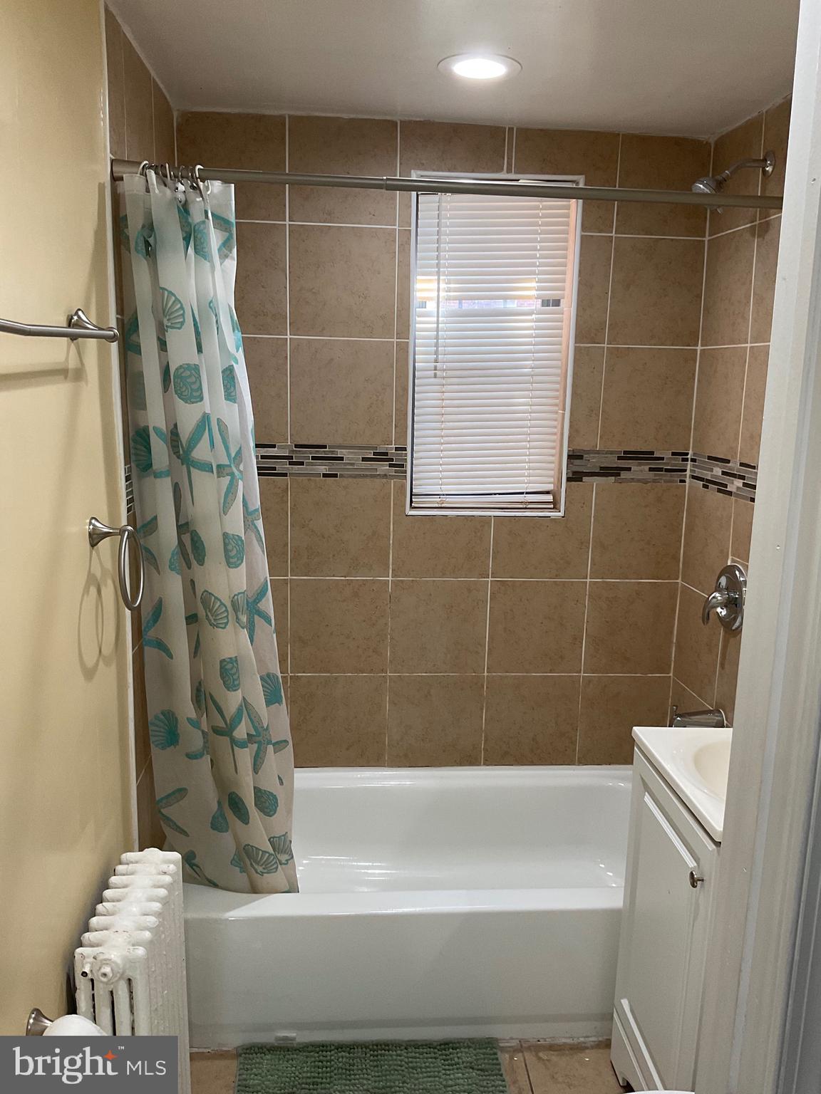 6 Galveston Street Southwest, Unit 103 Washington, DC 20032 - Photo 15 of 17 a bathroom with a bathtub and shower
