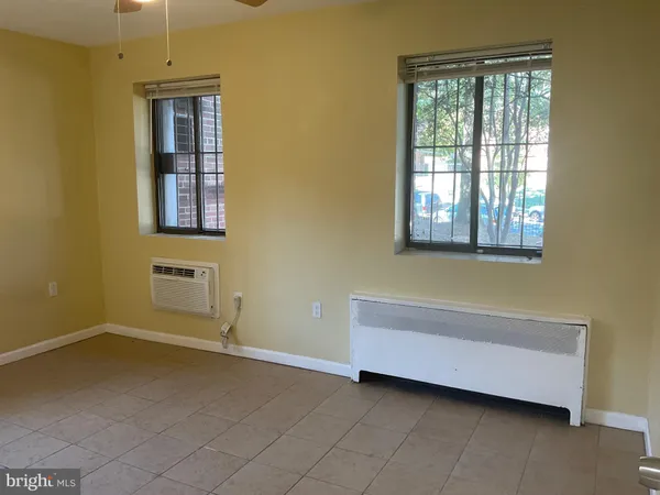 a bathroom with a bathtub and a window