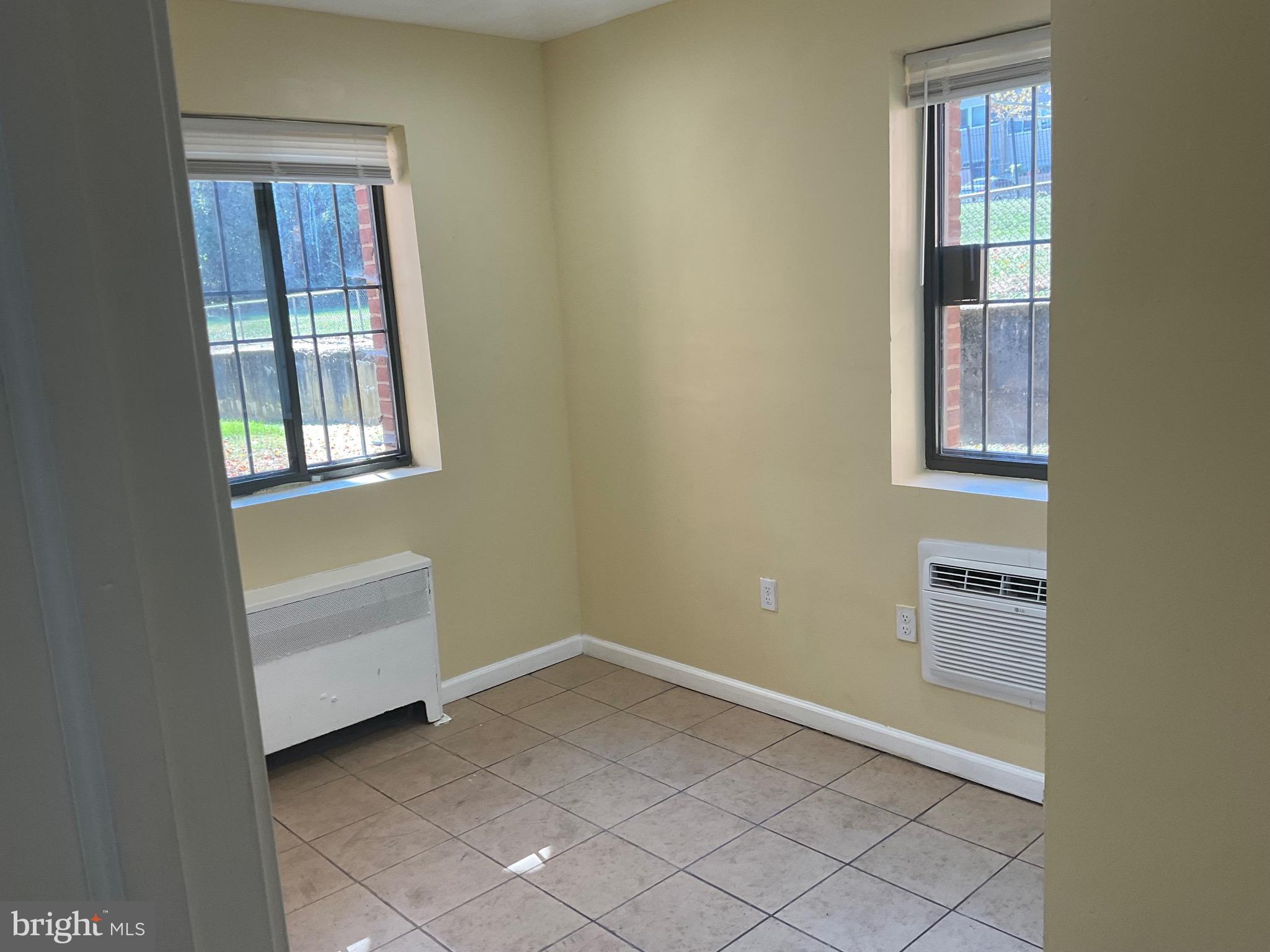 6 Galveston Street Southwest, Unit 103 Washington, DC 20032 - Photo 6 of 17 an empty room with windows and closet