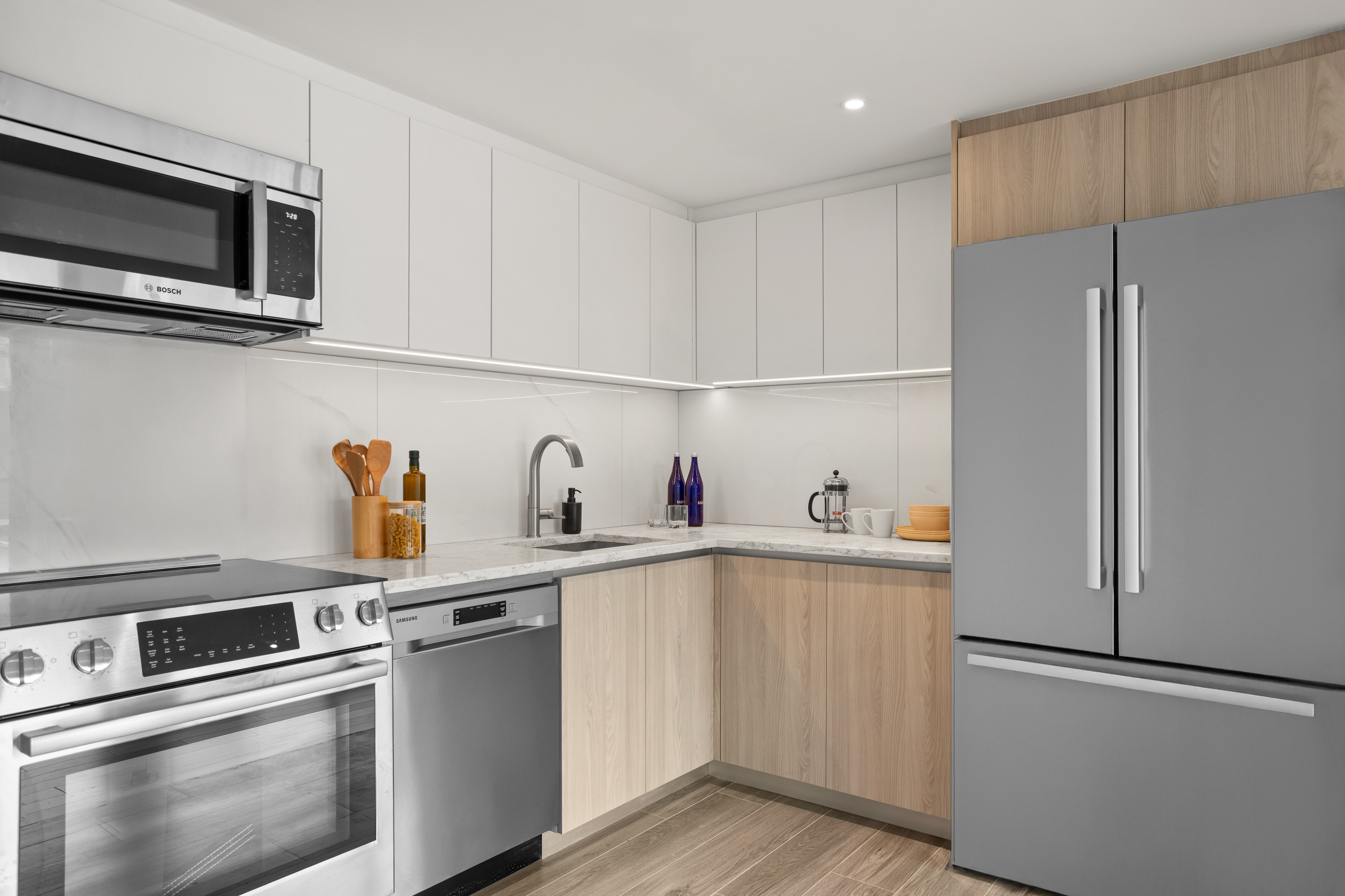 a kitchen with stainless steel appliances a refrigerator sink and microwave