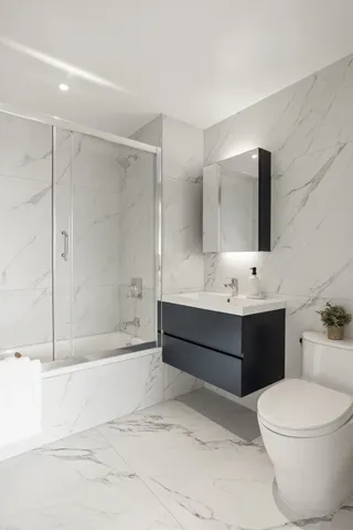 a bathroom with a toilet a sink and bathtub