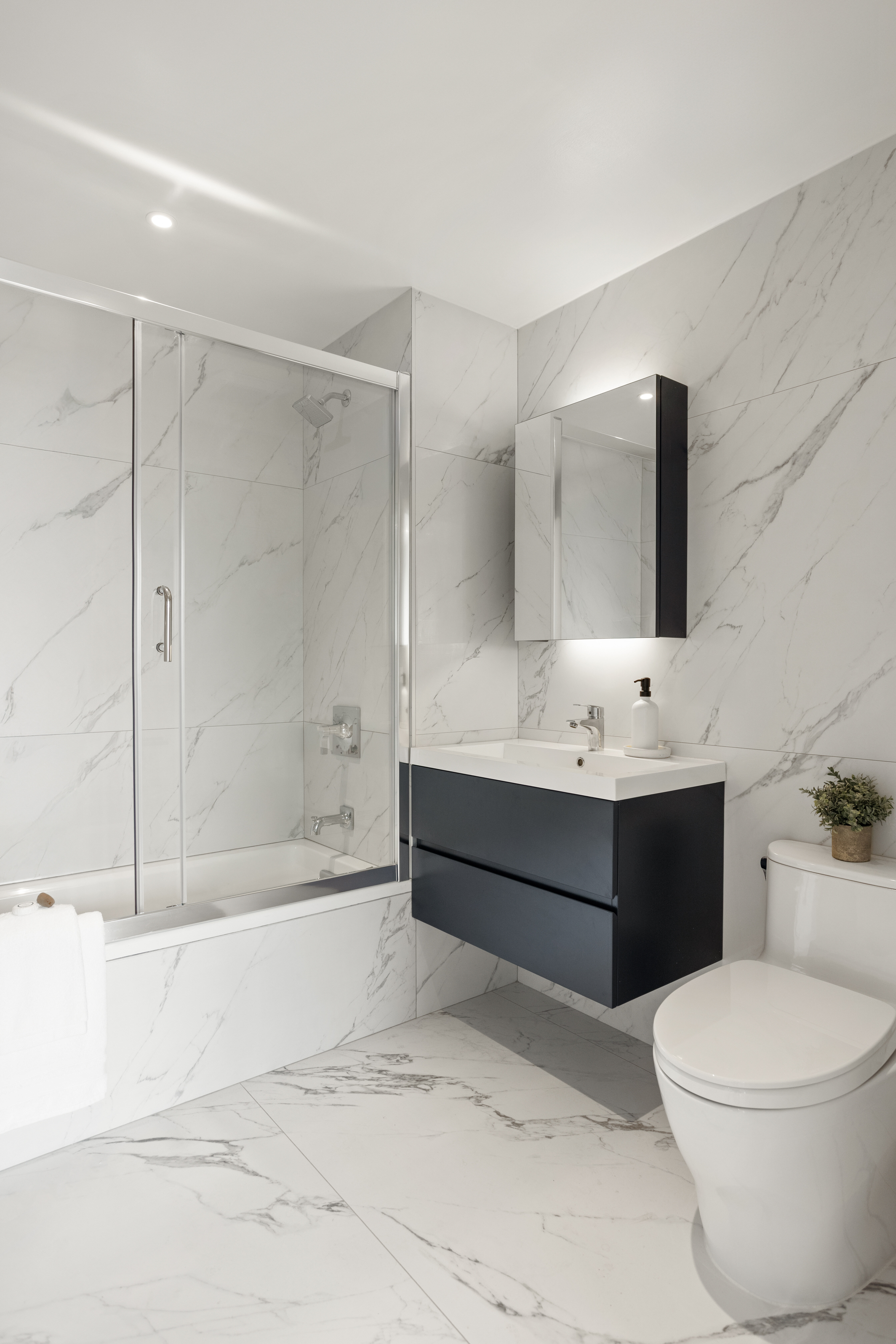 40-21 27th Street, Unit 6C Queens, NY 11101 - Photo 2 of 4 a bathroom with a toilet a sink and bathtub