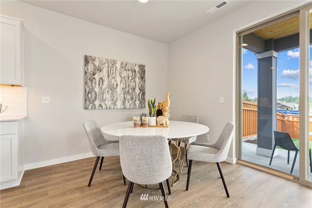 a living room with furniture wooden floor and a large window