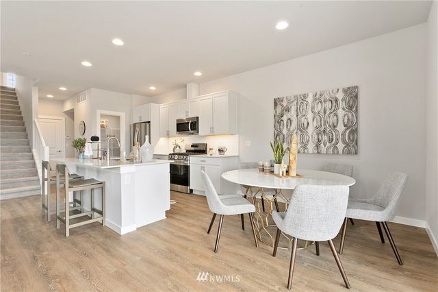 a living room with furniture potted plant and a floor to ceiling window