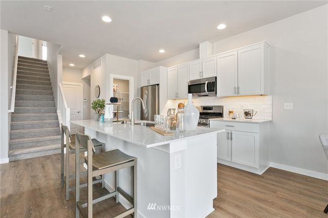 a kitchen with stainless steel appliances granite countertop a lot of counter space and a sink