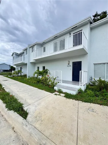 a front view of a house with a yard and a garage
