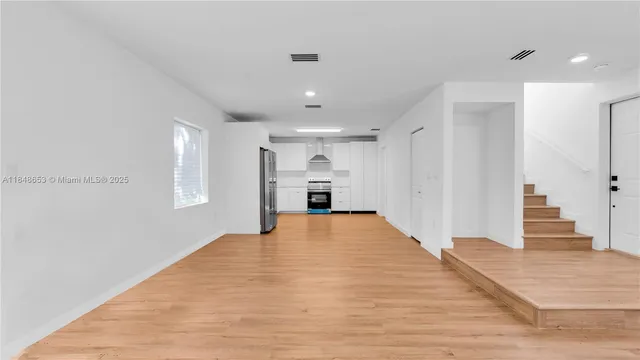 a view of hallway with wooden floor