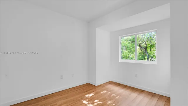 a view of a room with wooden floor