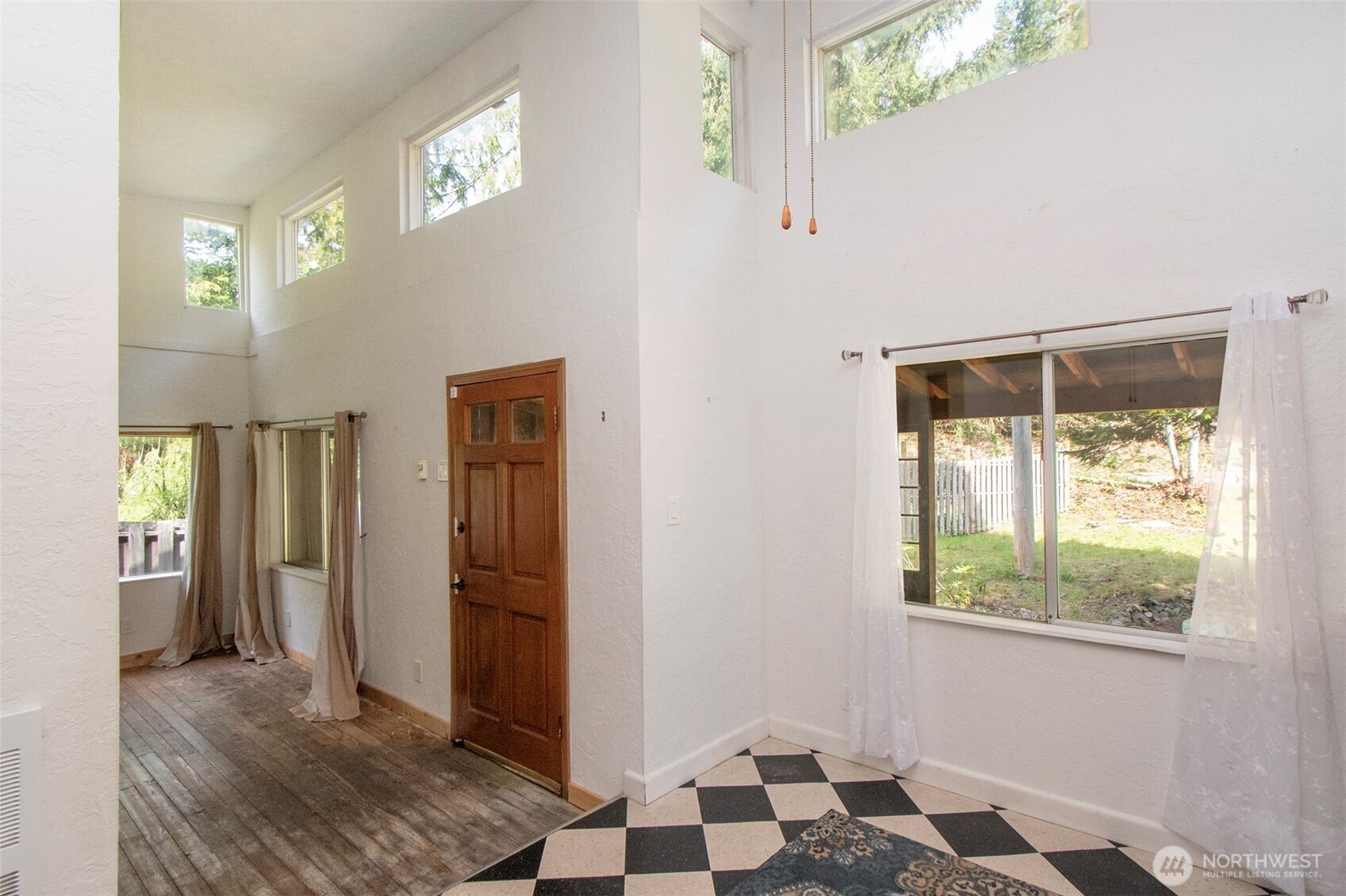 834 Little River Road Port Angeles, WA 98363 - Photo 10 of 40 a view of a hallway with wooden floor and a living room