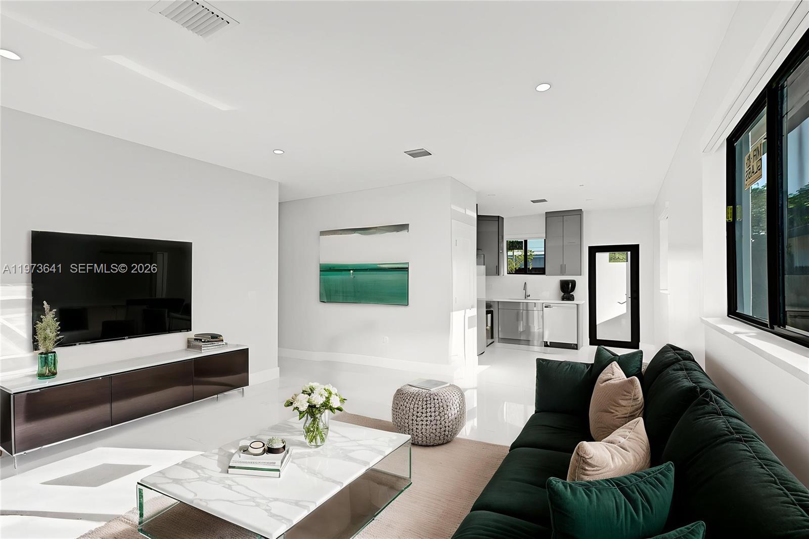 a living room with furniture and a flat screen tv