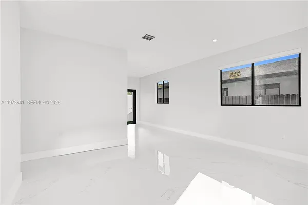 a kitchen with a refrigerator and a stove top oven