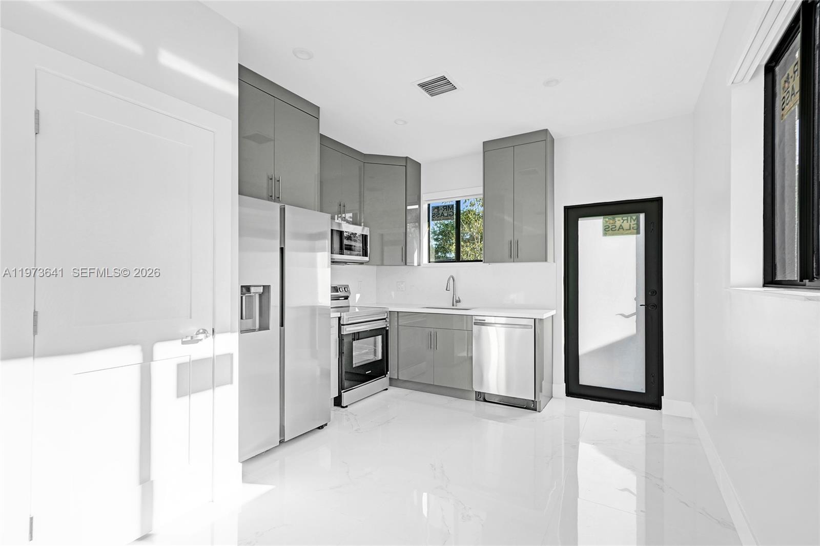12120 Southwest 219th Street, Unit B Miami, FL 33170 - Photo 13 of 53 a kitchen with a refrigerator and a stove top oven