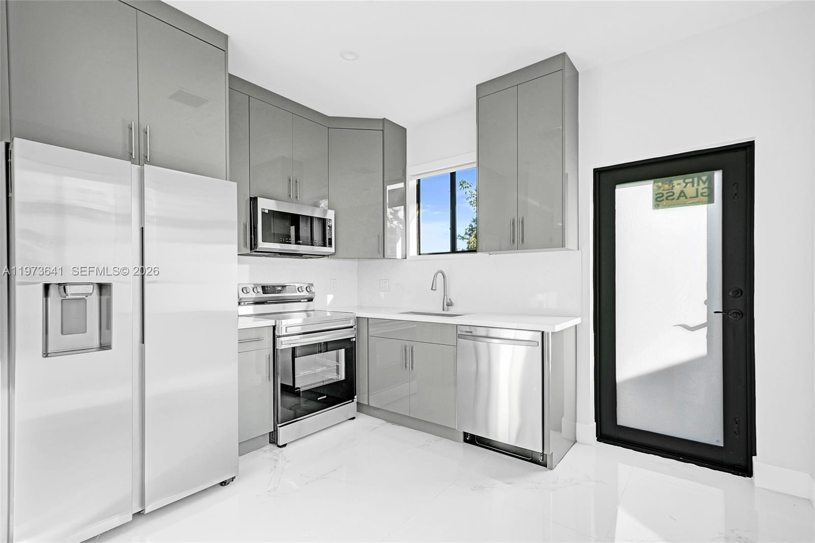 12120 Southwest 219th Street, Unit B Miami, FL 33170 - Photo 14 of 53 a kitchen with stainless steel appliances granite countertop a refrigerator and a stove top oven