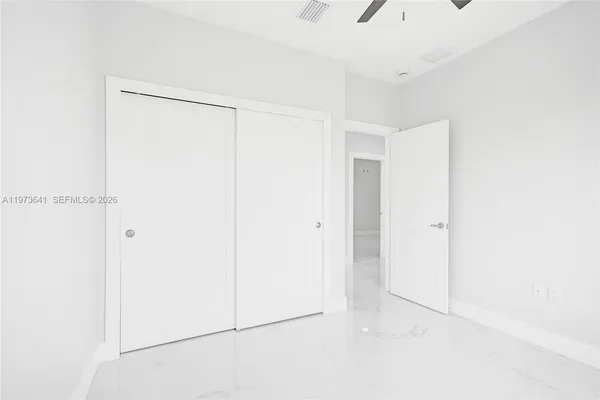 a bathroom with a window and a ceiling fan