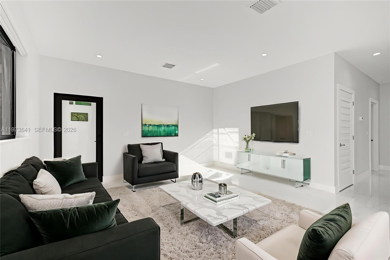 12120 Southwest 219th Street, Unit B Miami, FL 33170 - Photo 2 of 53 a living room with furniture and a flat screen tv