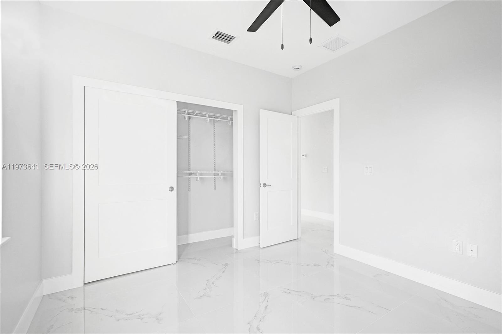 12120 Southwest 219th Street, Unit B Miami, FL 33170 - Photo 25 of 53 an empty room with a ceiling fan and carpet