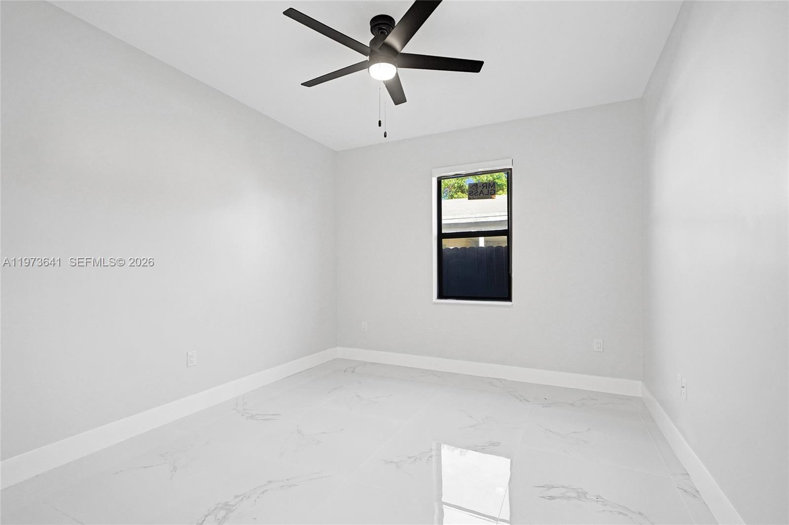 12120 Southwest 219th Street, Unit B Miami, FL 33170 - Photo 29 of 53 an empty room with a window and a ceiling fan