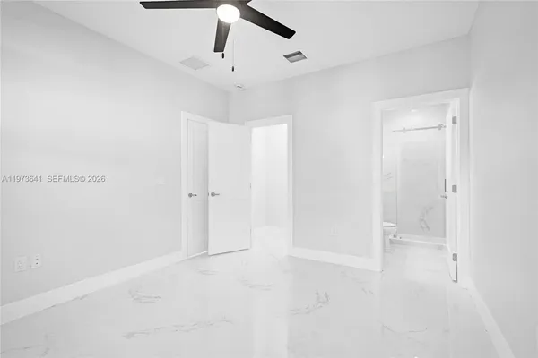 a bathroom with a sink mirror shower and toilet