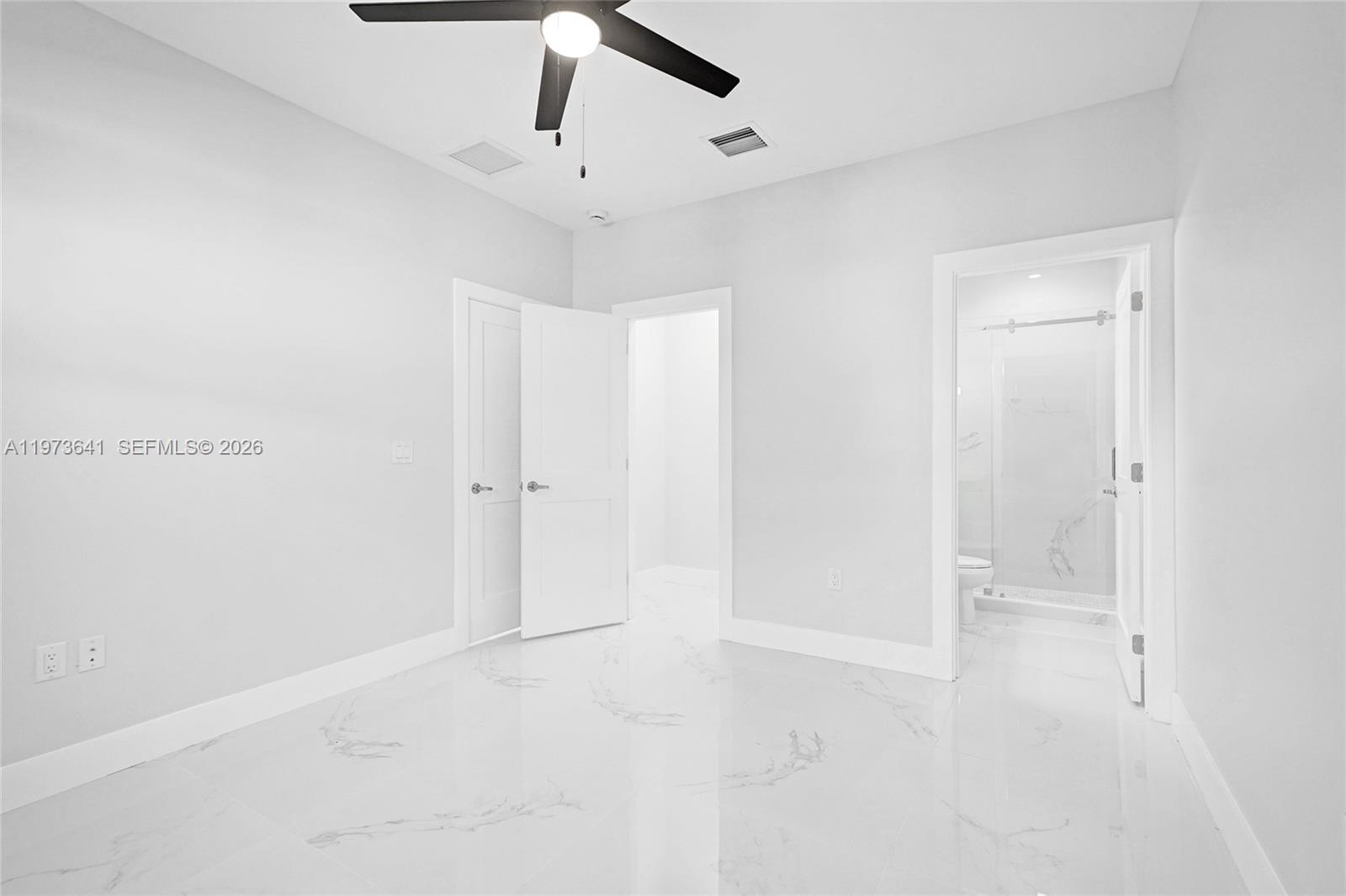 12120 Southwest 219th Street, Unit B Miami, FL 33170 - Photo 31 of 53 an empty room with a ceiling fan and carpet
