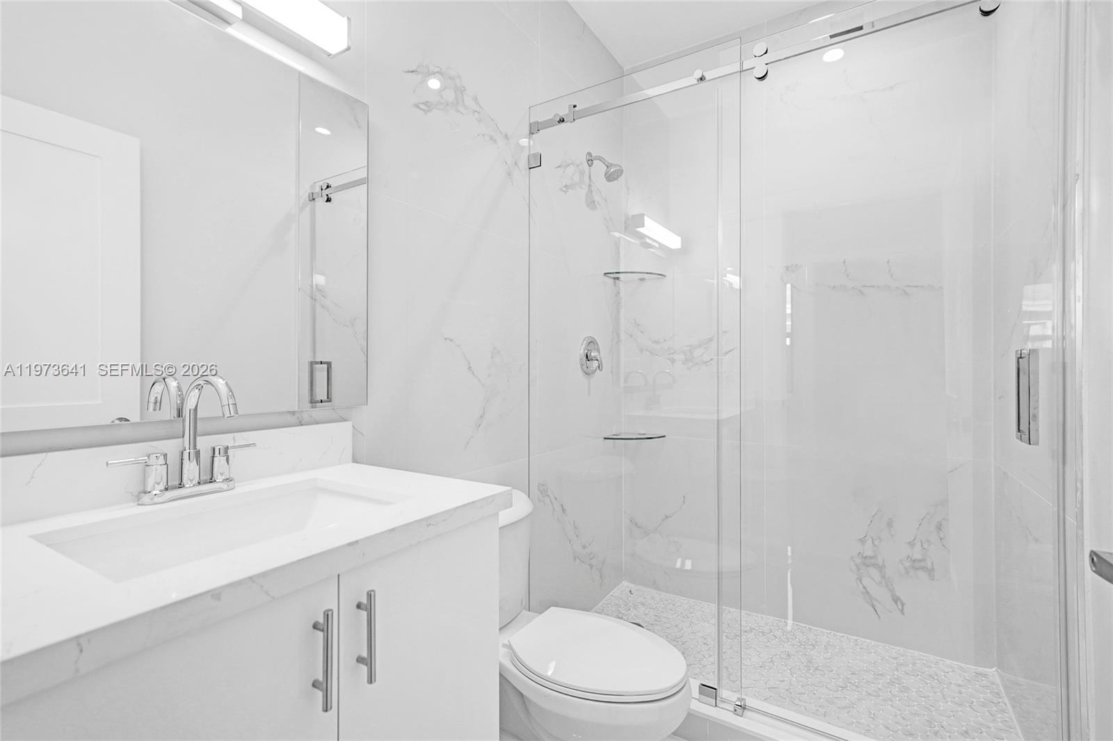 12120 Southwest 219th Street, Unit B Miami, FL 33170 - Photo 32 of 53 a bathroom with a sink mirror shower and toilet