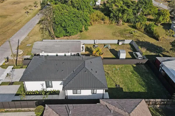 an aerial view of a house with a yard and potted plants