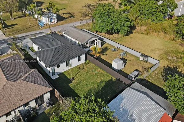 an aerial view of residential houses with outdoor space