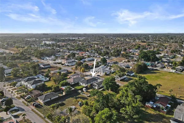 an aerial view of residential building with trees