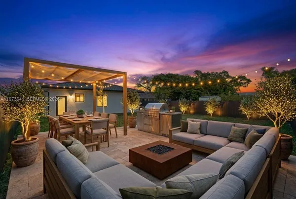 a roof deck with couches and wooden floor