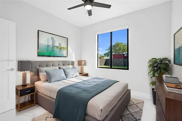a bedroom with a bed and a potted plant